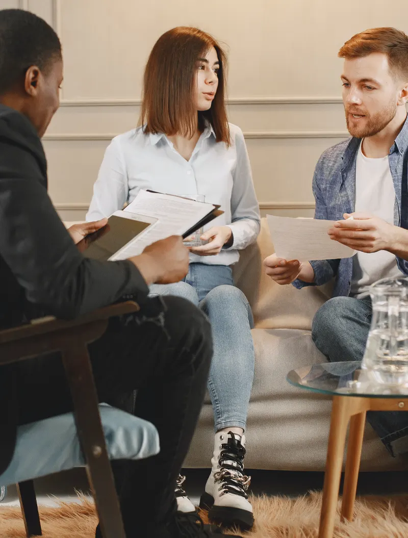 couple-comparing-notes-with-marriage-counselor