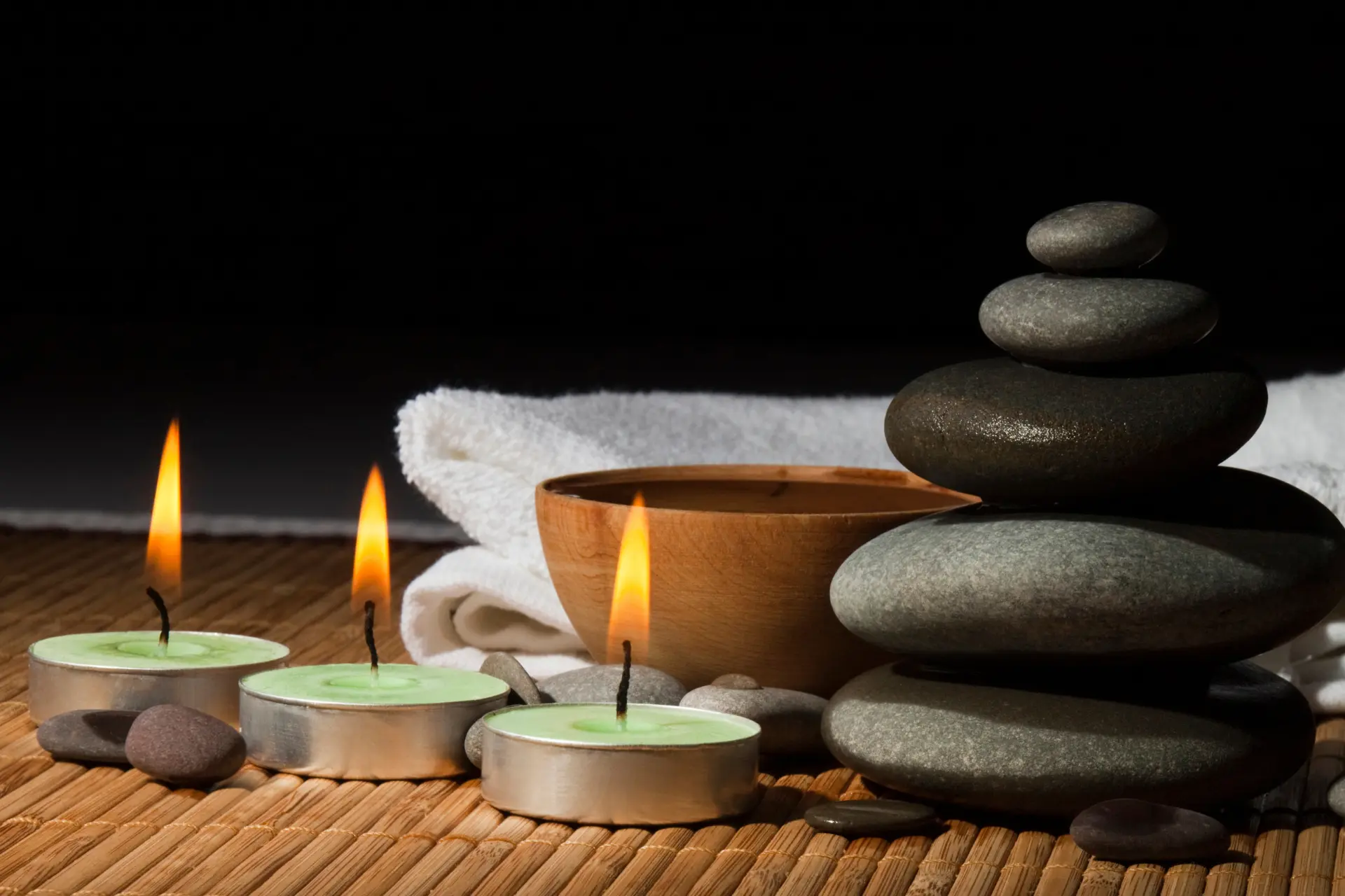 candles, hot rocks, and towel for massage